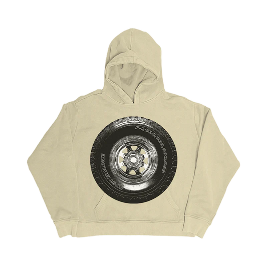 Post Malone Tire Hoodie front view featuring oversized chrome wheel and truck tire artwork with Post Malone and F-1 Trillion inspired detailing printed above the kangaroo pocket on a sand-colored heavyweight pullover hoodie