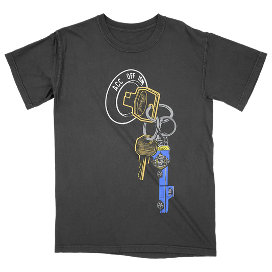 Post Malone F-1 Trillion Keys T-Shirt front view featuring ignition keychain graphic with truck key, motel tag and road trip inspired artwork from the F-1 Trillion collection on charcoal tee