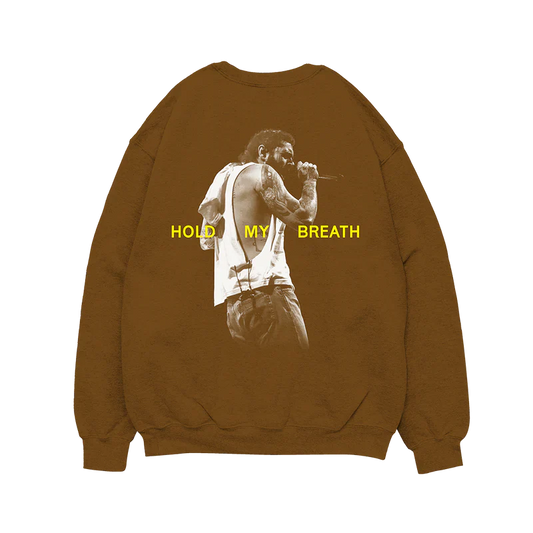 Post Malone Hold My Breath Crewneck front view featuring Austin album branding with yellow chest graphic on brown sweatshirt