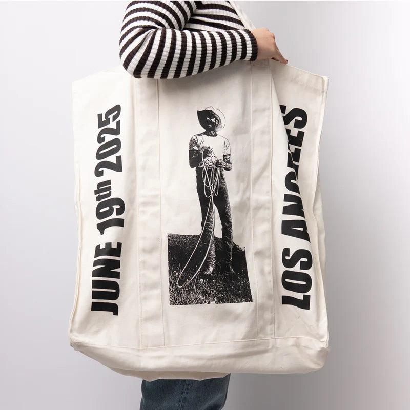 Large Post Malone LA Big Ass Stadium Tour tote bag with cowboy graphic shown in lifestyle front view