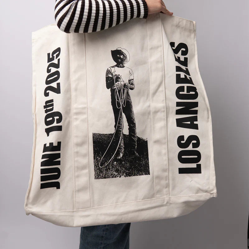 Post Malone LA Big Ass Stadium Tour tote bag side view with cowboy artwork displayed in lifestyle setting